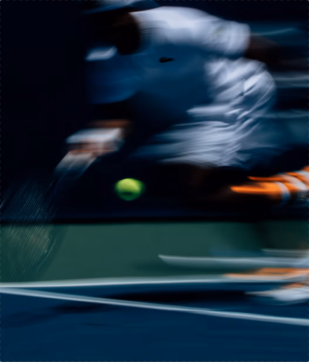 Blurred image of tennis player hitting a ball on a blue court.